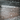 Snowflakes falling on a concrete surface with a dark background